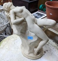 A contemporary resin plaster style conservatory statue of a naked woman reclining on a boulder, 38cm