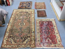Five rugs to include a Turkish beige ground rug, Caucasian red ground rug and three prayer mats
