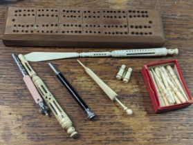 A group of five Stanhopes to include a Souvenir of Brighton example in a worked bone needle holder