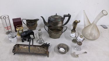 A mixed lot to include a silver spoon, silver plated tea set, miniature clock and other items