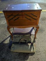 An early 20th century mahogany sewing box with cantilevered top, on cabriole legs, fitted interior