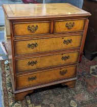 A late 20th century elm finished chest of two short and three long drawers on bracket feet, 74cm h x