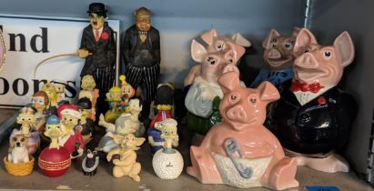 A collection of Eggbert figures along with a wooden figure of Charlie Chaplin and Winston