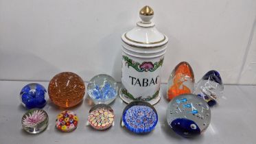 A collection of nine paperweights to include a millefiori example and a 20th century tobacco jar