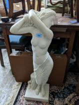 A contemporary resin Parian ware style conservatory statue of a semi-clad maiden on square base,