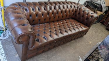 A brown leather button back chesterfield sofa 74hx212w Location:CONR