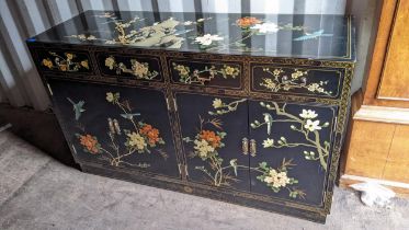 A late 20th century oriental black lacquered sideboard decorated with flowers and birds, with four