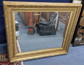 A early 20th century carved gilt gesso picture frame, fitted with a mirror, 87.5cm h x 101.5cm w