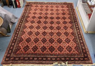 A Turkish hand woven rug having a red ground, multi-guard borders and tasselled ends, 295cm x