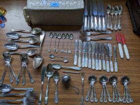 A selection of white metal and American sterling silver and silver plated flatware to include a
