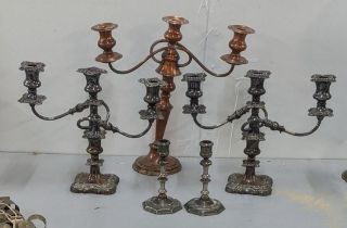 A pair of early 20th century silver plate on copper three branch candelabra together with a pair