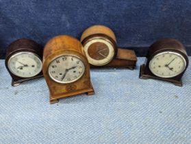 A group of four mantle clocks to include an Edwardian arch top 8 day mantle clock in a mahogany
