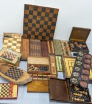 A collection of Cribbage boards together with a chess board and chess pieces together with a Mancala