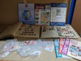 Two vintage stamp albums containing a small selection of stamps from around the world including GB