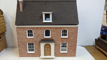 A mid 20th century dolls house with an opening front and hinged roof Location: G