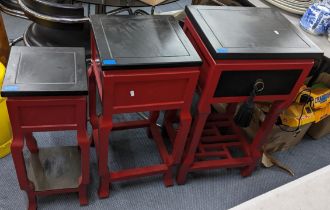 Three Oriental style black and red lacquered side tables to include one inset with a drawer, 81.