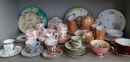 A collection of decorative coffee cans and tea cups with saucers and miscellaneous collectors plates