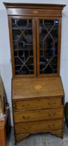 An Edwardian Sheraton revival inlaid walnut and mahogany bureau bookcase, astragal glazed twin