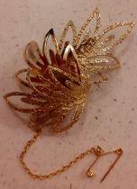 A 9ct gold brooch fashioned as foliage, stamped 375, having a yellow metal safety chain, total
