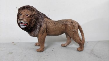 A modern Bergmann style painted metal model of a lion Location: