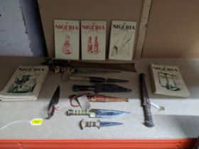 A group of African daggers and a machete, some in leather sheaths, circa 1940 and a group of