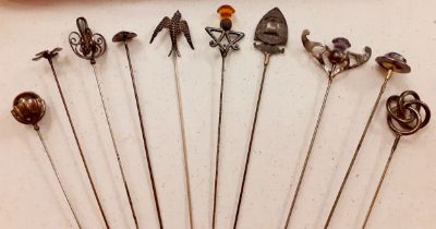 A quantity of 10 early 20th Century silver and white metal hat pins to include an open knot design