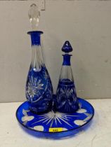 A clear and blue glass tray, and two similar decanters with line cut decoration Location: