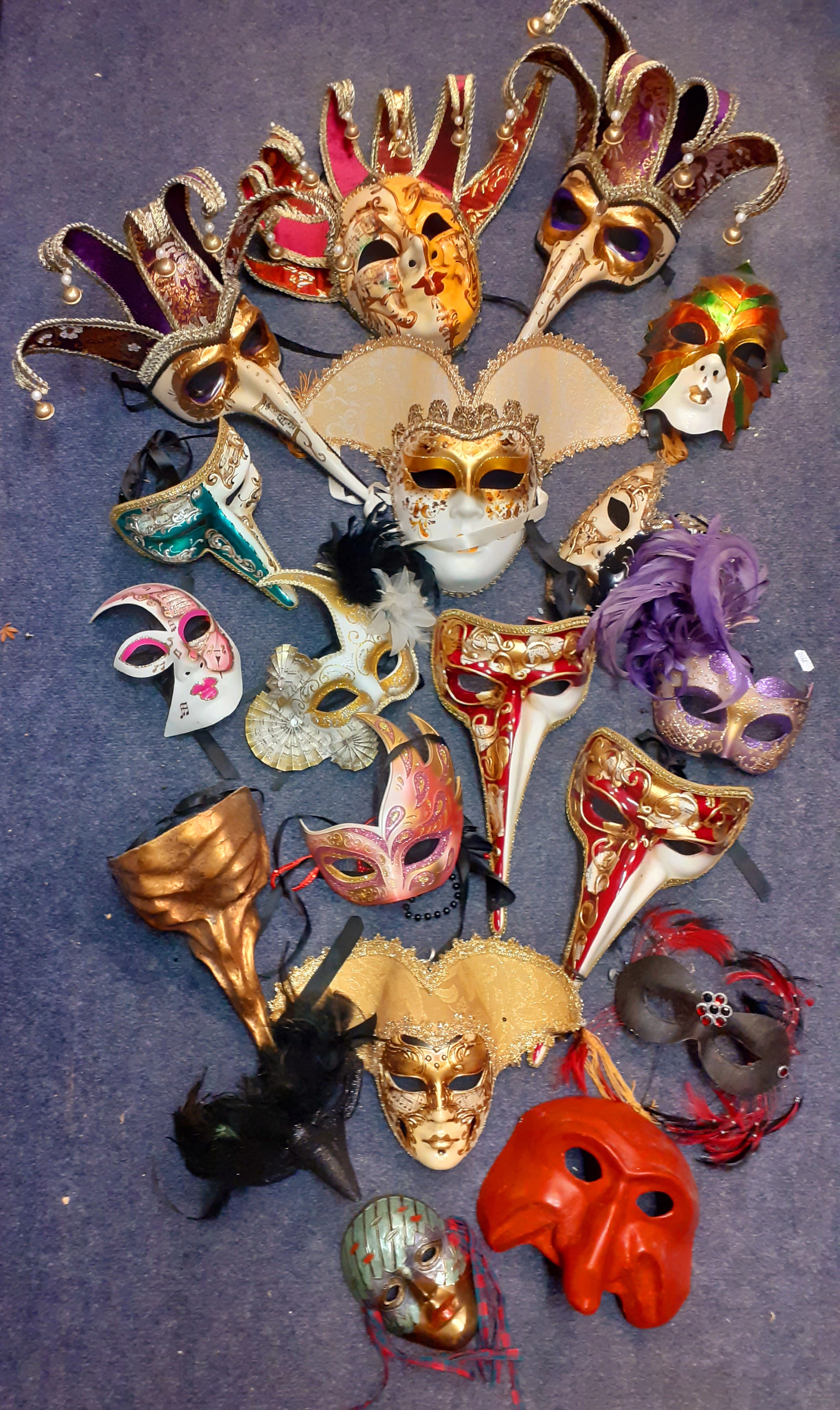 A quantity of decorative masquerade masks to include hand-painted Venezia examples.