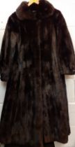 A vintage black mink coat 36/38" chest x 45" long having bellow sleeves with black leather bow