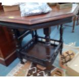 An early 20th century occasional table with galleried shelf below and another