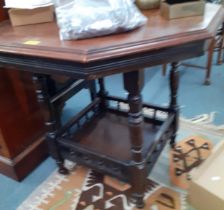 An early 20th century occasional table with galleried shelf below and another