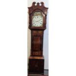 An early 19th century mahogany longcase clock, the case having a broken swan neck pediment and