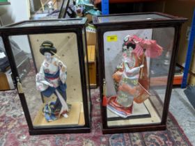 Two 20th century Japanese porcelain figures in traditional costume in glass display cases Location: