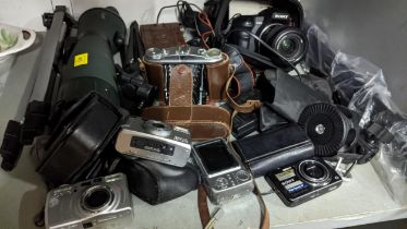 A selection of digital cameras and accessories to include a Sony OC200, Pentax ESP10 120Mi, and