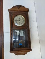 An early 20th century oak wall clock with bevelled glass panels Location:G