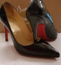 Christian Louboutin- A pair of black Patent leather stiletto shoes with iconic red soles and nude