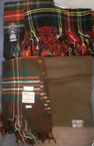 Four vintage tartan woollen rugs comprising an Earl-Wood 'Black Stewart tartan travel rug, a Burns