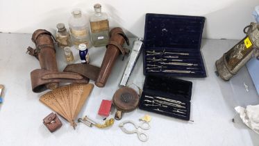 A mixed lot to include a silver plated egg topper, a leather cased hunting flask, pharmacy bottles