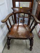 A 19th century oak and elm Captain's chair, bar back, scrolled end arms, supported on turned