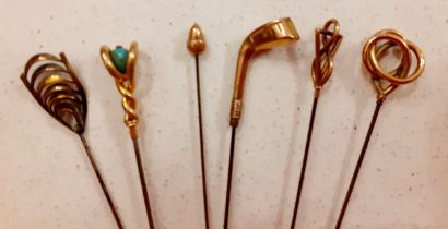Five early 20th Century 9ct gold topped hat pins, one with 9ct gold acorn design, one having a 9ct