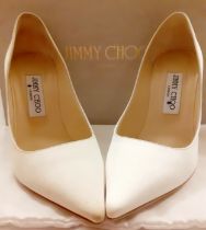 Jimmy Choo-A pair of cream satin wedding shoes having 10 cm high heels, European size 37, hardly