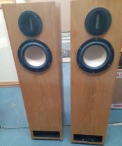 A late 20th/early 21st Century pair of tall speakers in a light oak casing, 90"h x 12" d x9.5" d.