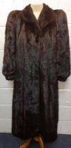 A 1980's dark brown mink coat (almost black to the eye) having a shawl collar, raised and padded