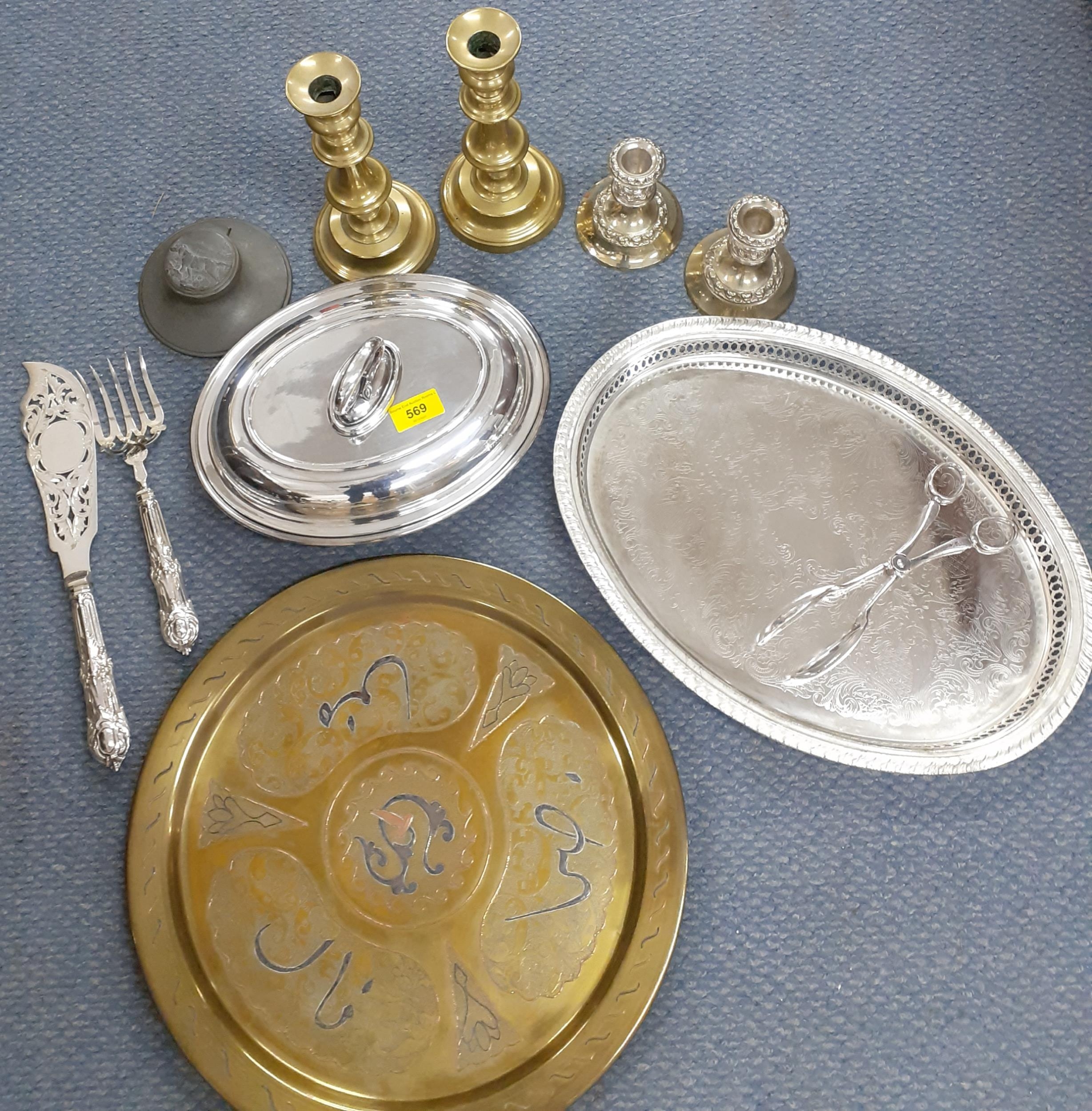 A quantity of metalware to include a pair of brass candlesticks, a pair of silver plated examples, a