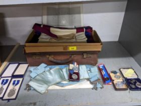 A leather case containing Masonic aprons, and various medals to include a silver WMSS Prize medal, a