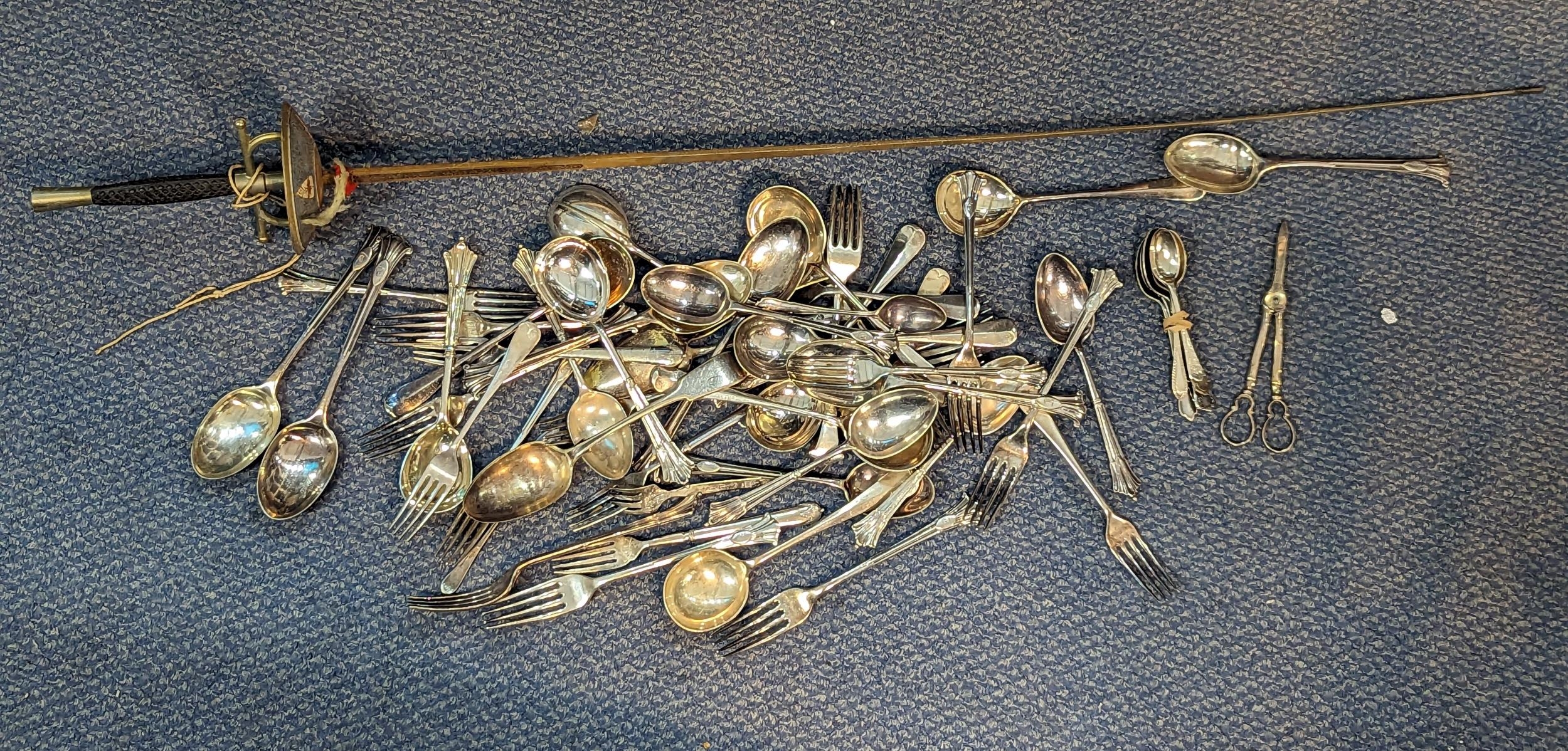 A selection of mixed silver plated flatware to include forks, spoons, scissors, and others, along