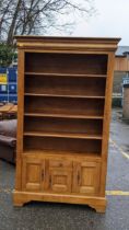 A modern French style oak bookcase cabinet with four shelves, a drawer and three doors Location: CON