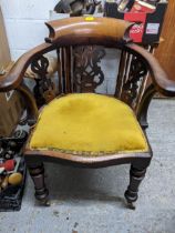 A Victorian oak desk chair, pierced centre and side splats, scrolled end arms, on turned front