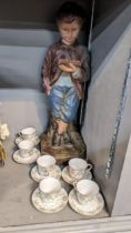A set of Art Nouveau Doulton E4063 cups and saucers, together with a plaster figure of a boy