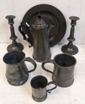A collection of 18th century and later pewter to include candlesticks, lidded jug and others